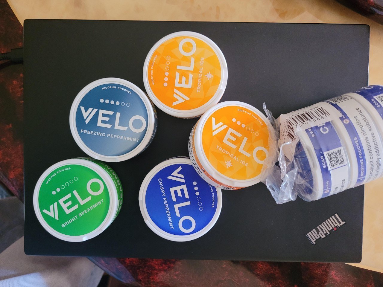 Assorted Velo nicotine pouches in various flavors and 6mg, 9mg, and 14mg strengths in 5-can packs.